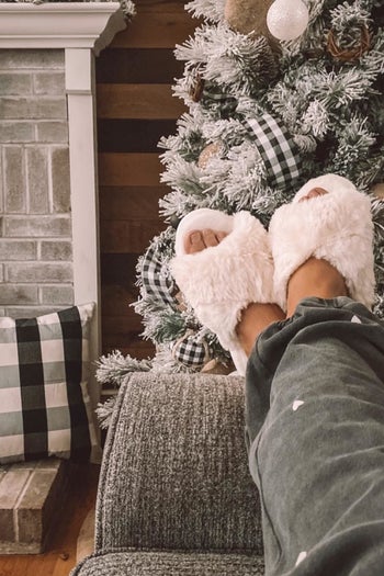 A reviewer wearing the slippers in beige