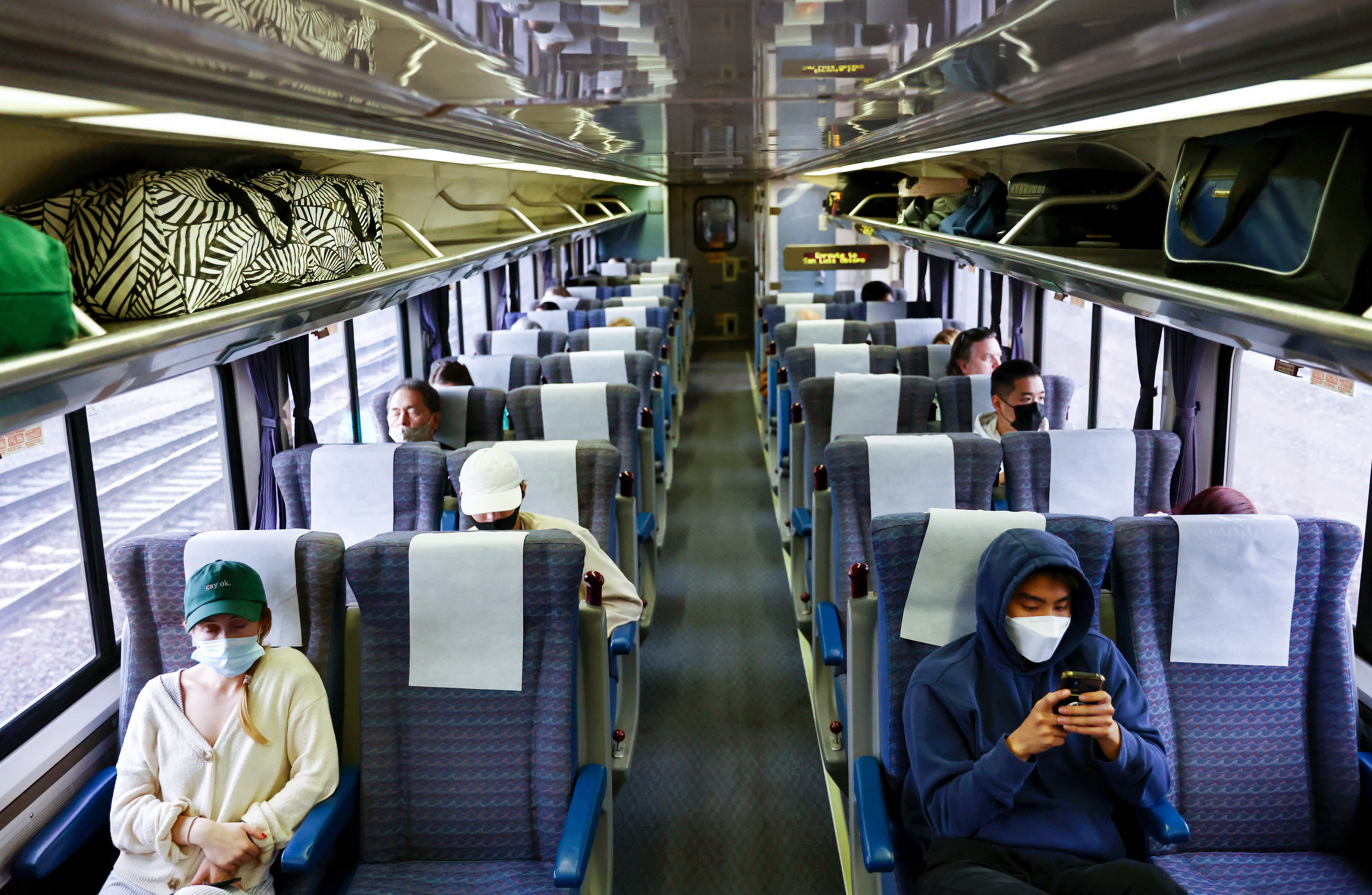 A handful of passengers ride a passenger train