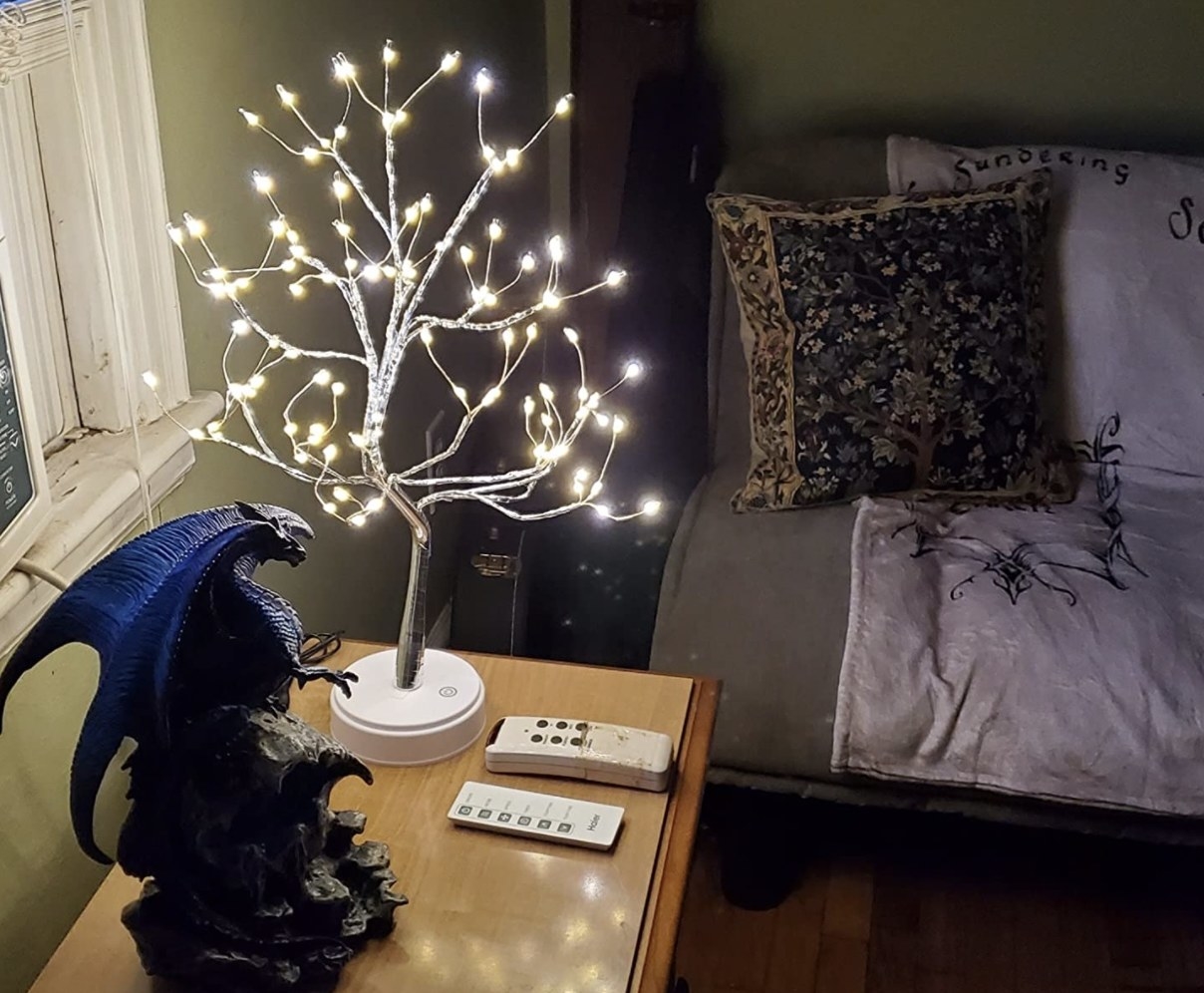 Reviewer&#x27;s photo of the white bonsai tree light on the side table