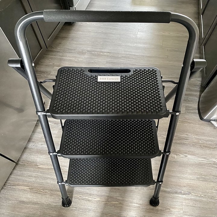 reviewer photo of the black three-step ladder in a kitchen