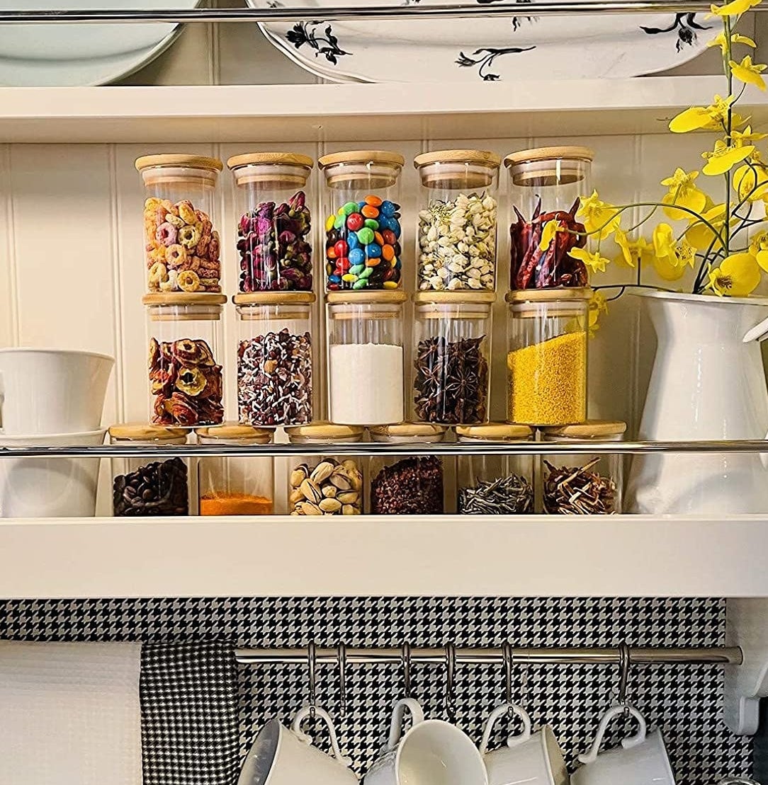 Several pantry jars filled with goodies on a kitchen shelf