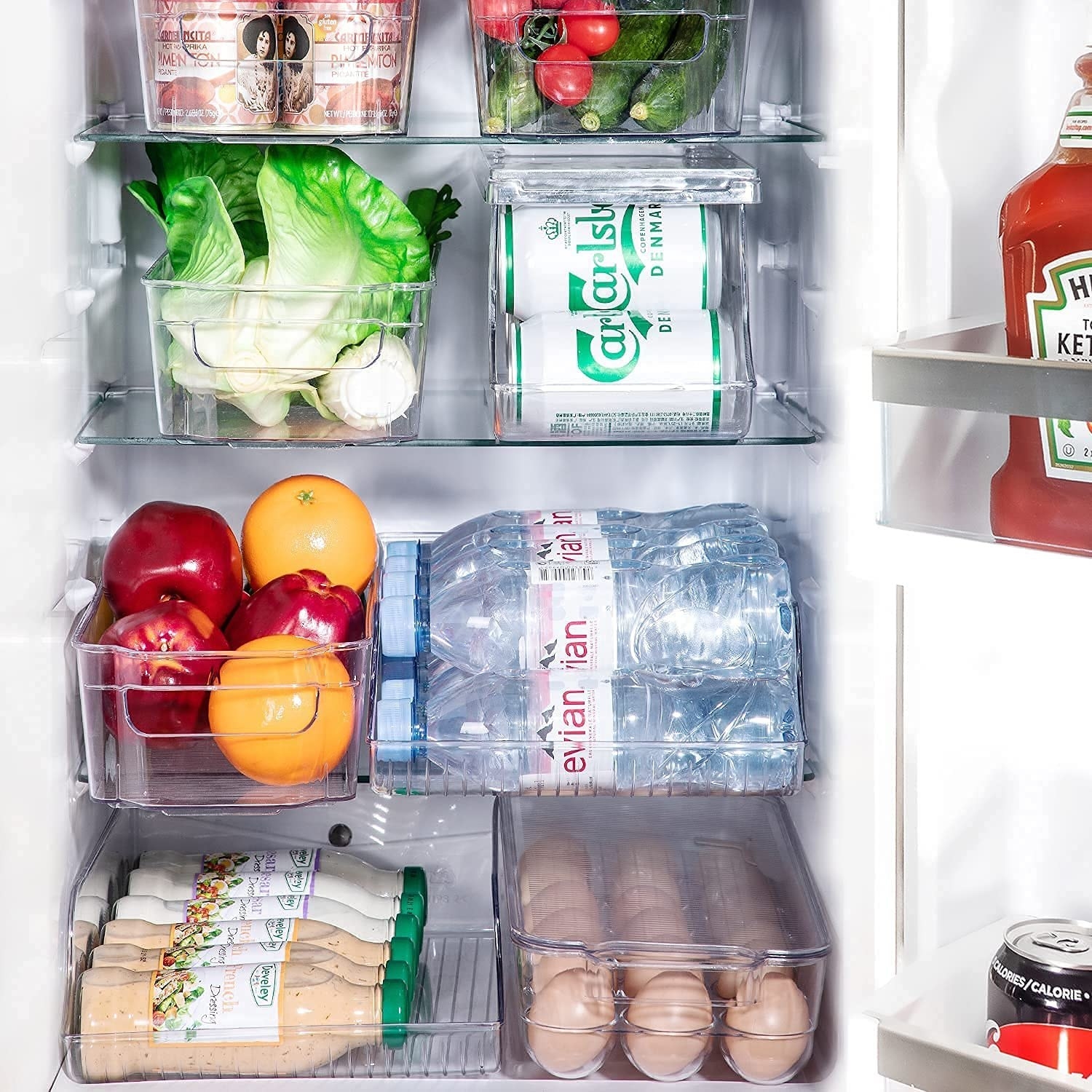 eggs, products, cans, bottles, and more divided into fridge organizers