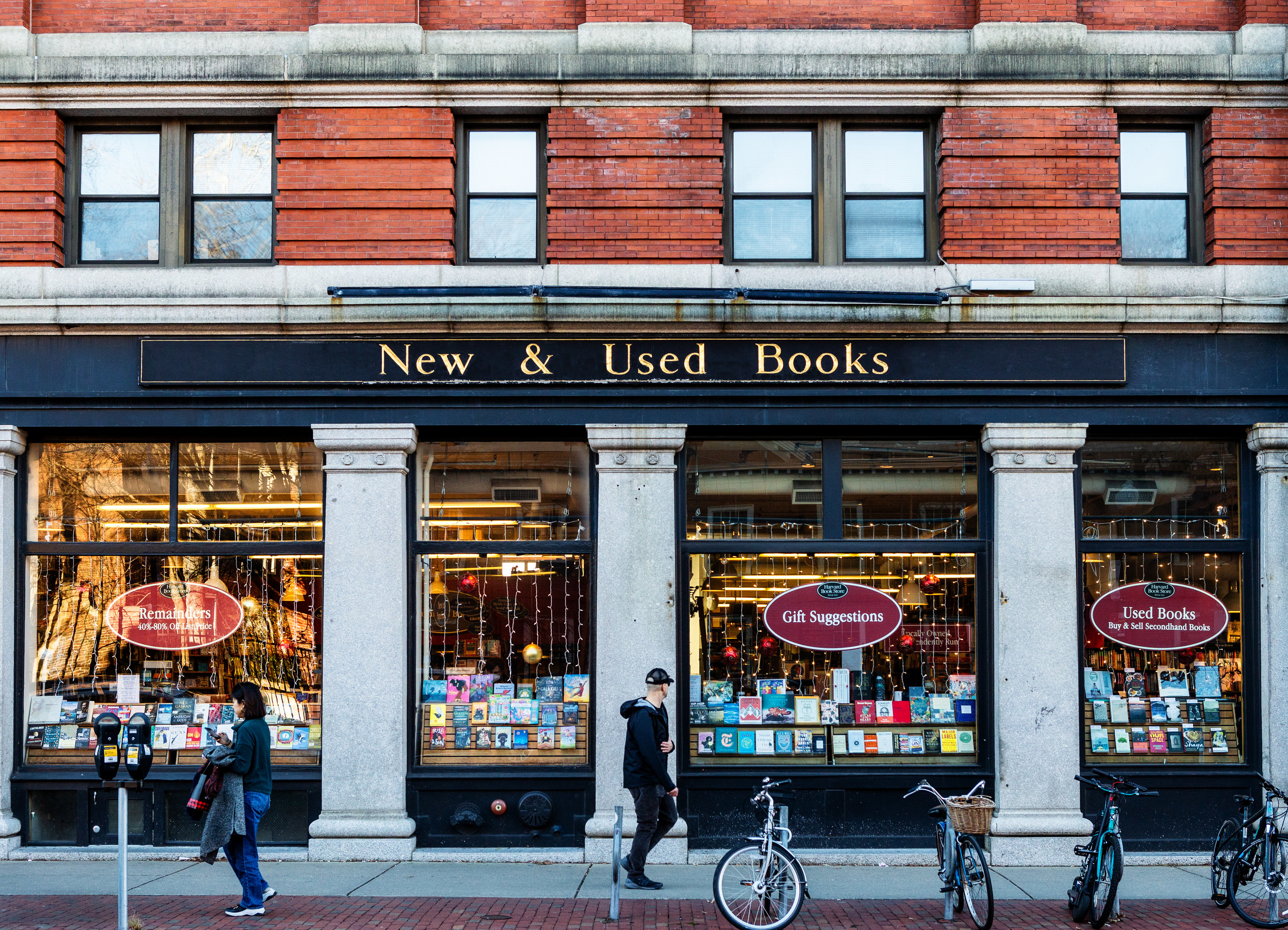 Pedestrians pass by a new and used bookstore