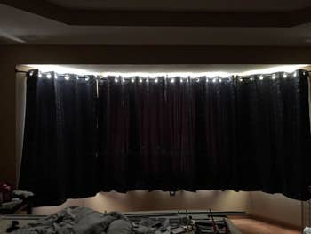 reviewer image of a room darkened by the light blocking curtains on the window