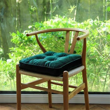 the dark green cushion on a chair