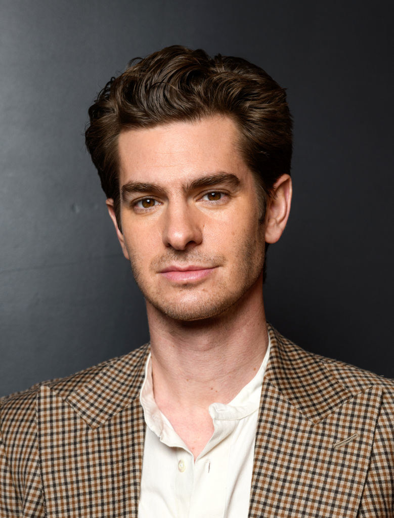 Headshot of Andrew wearing a checkered blazer and white button-down