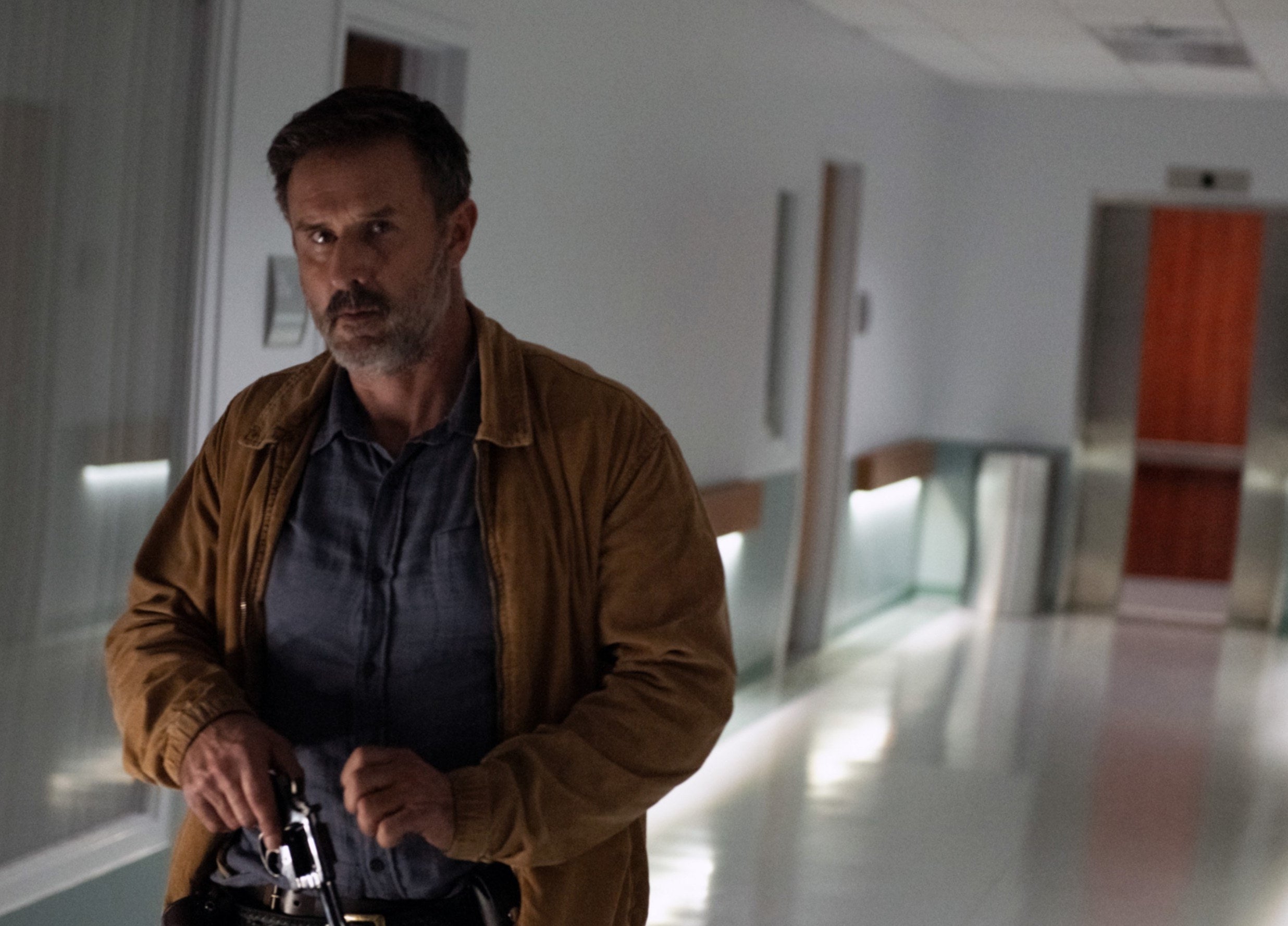 Dewey entering the hospital wielding a gun while in plains clothes