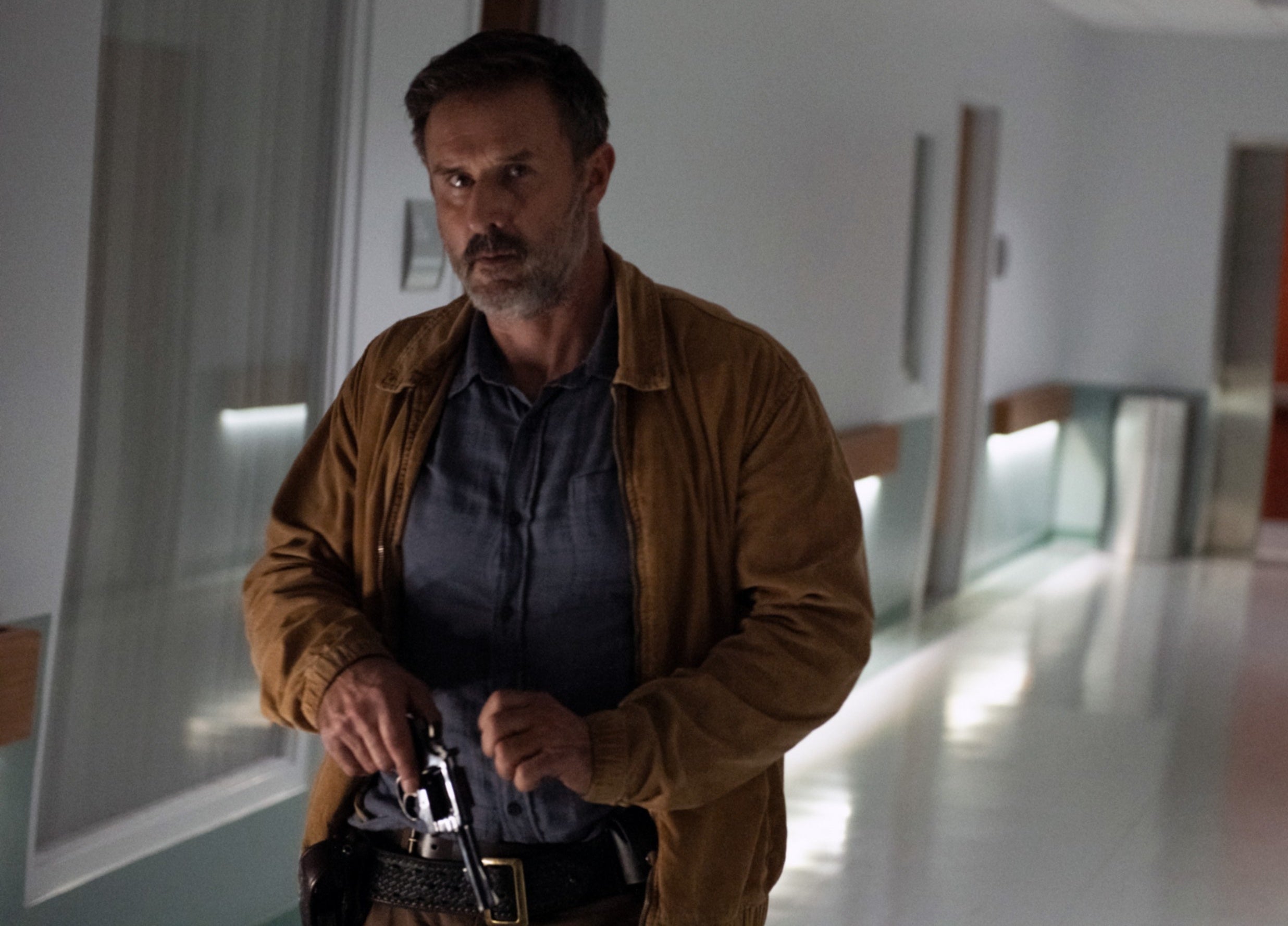 Dewey entering the hospital wielding a gun while in plains clothes