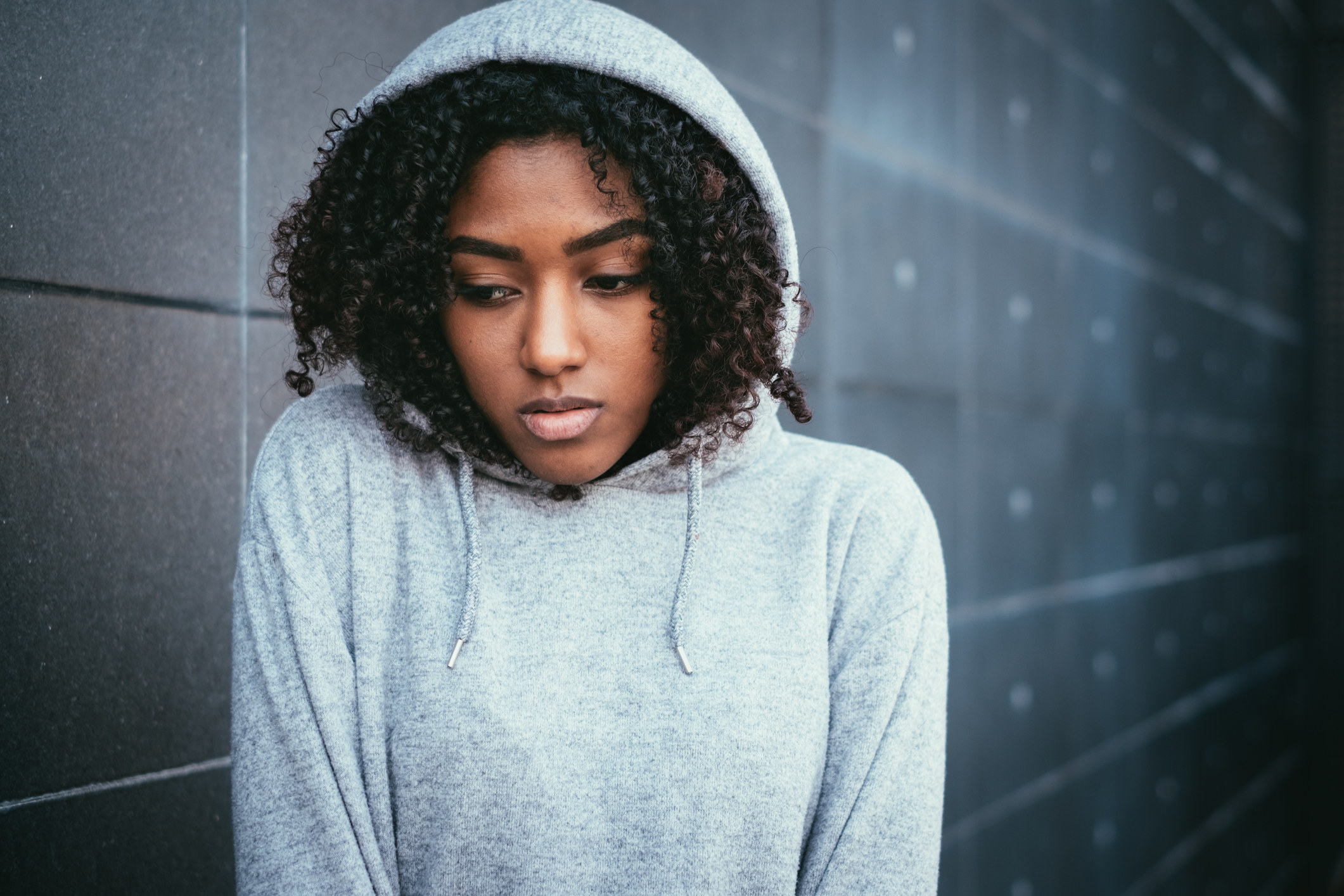 frightened teen girl in a hoodie