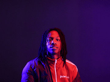 Joey Bada$$ opening his arms with text appearing over his head saying