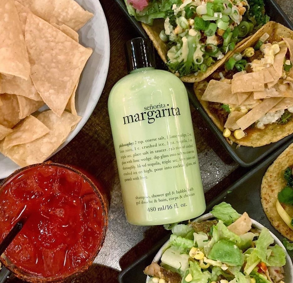 a bottle of the margarita-scented body wash nestled among tacos, salad, and nacho chips