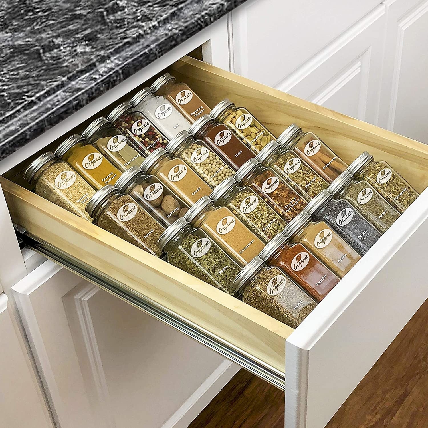 an open drawer with the angled spice rack inside