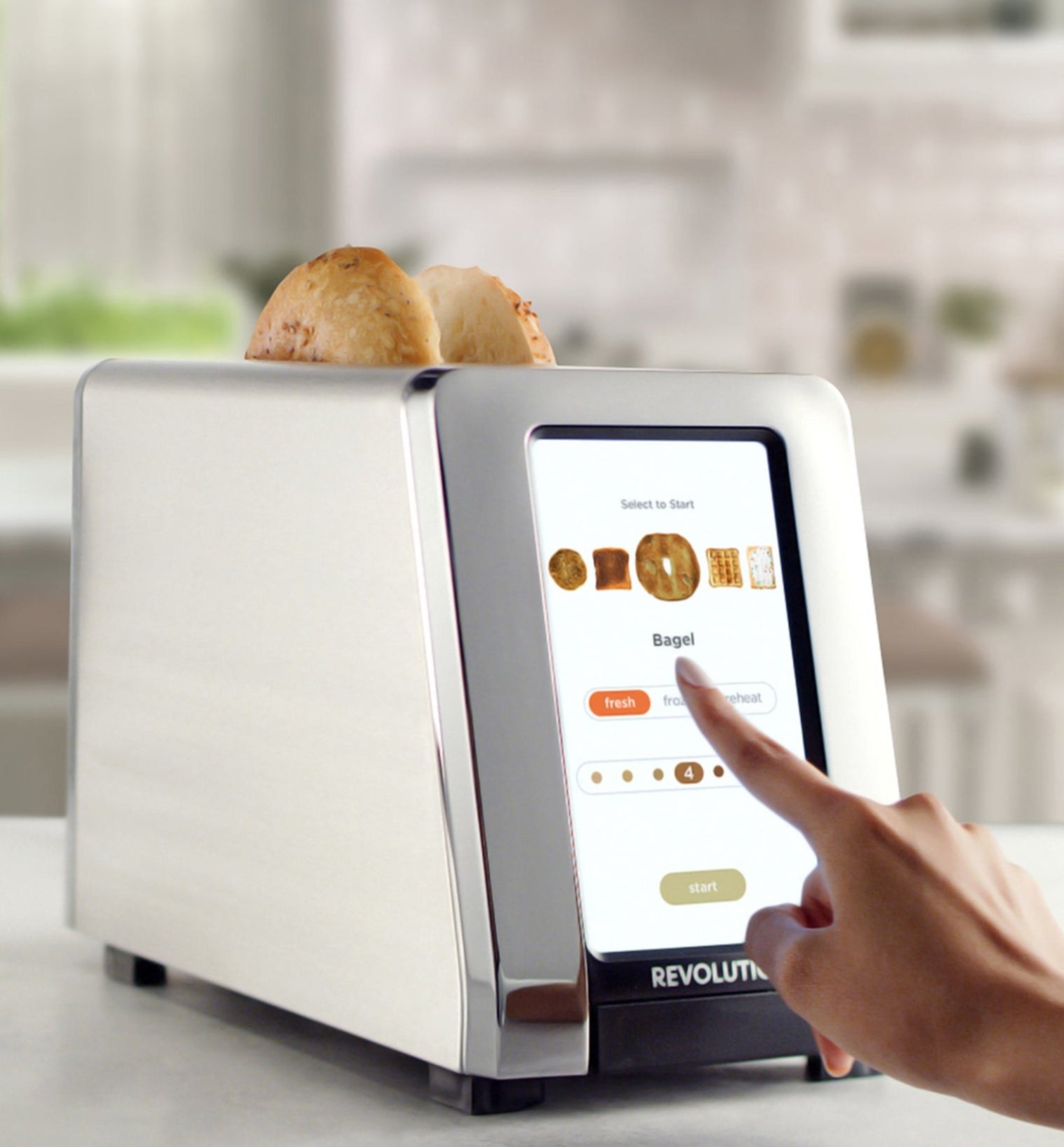 a model using the toaster to cook a bagel