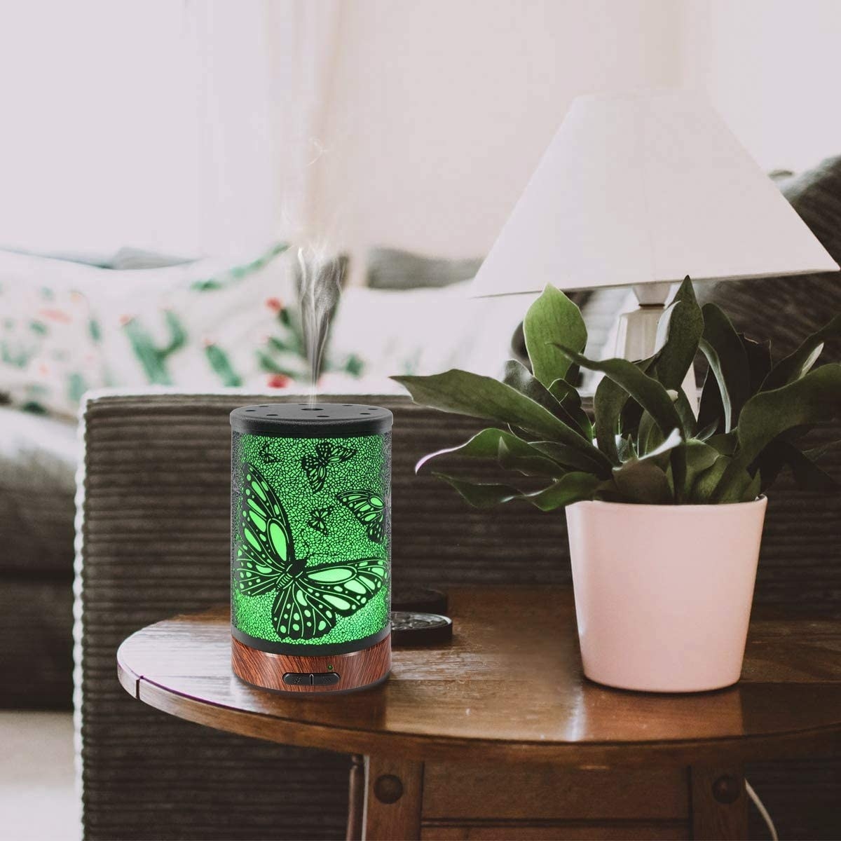 The butterfly diffuser on a coffee table next to a plant