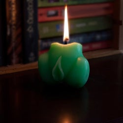 Green vulva candle burning