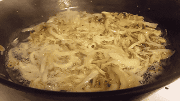 Onions cooking in oil in a skillet