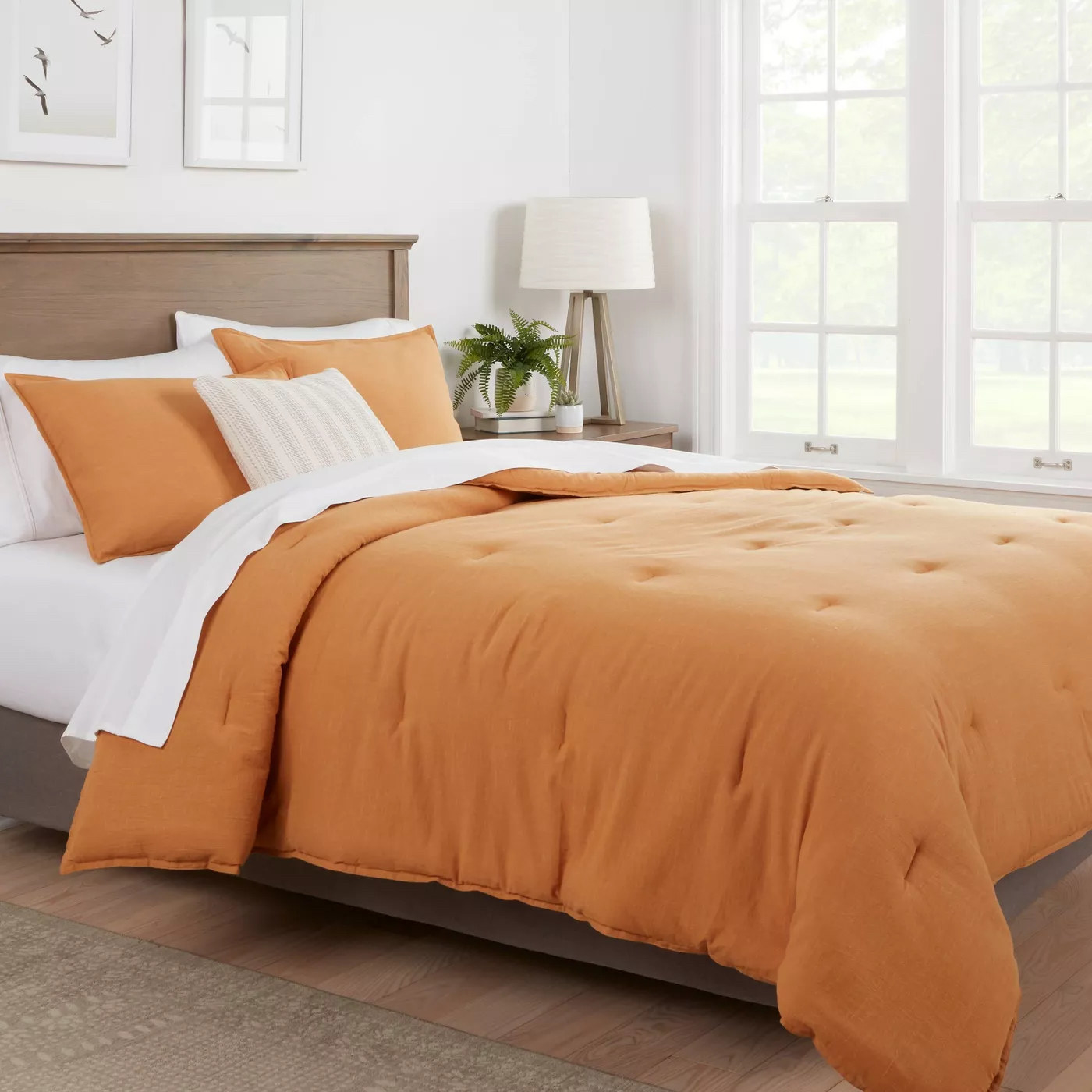 Orange comforter on bed