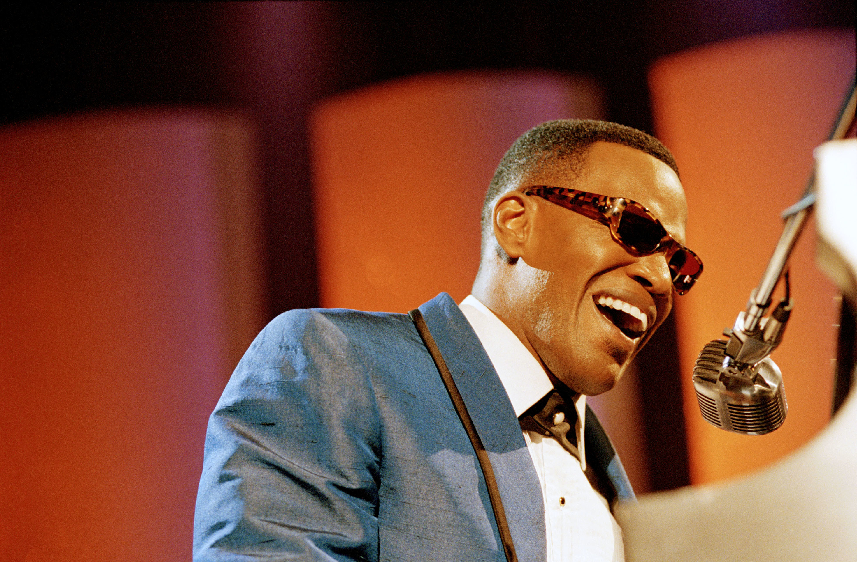 Jamie Foxx as Ray Charles at the piano and microphone