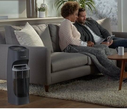lifestyle photo of black Honeywell humidifier on the floor of a living room