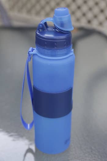 a reviewer photo of the blue water bottle completely erected