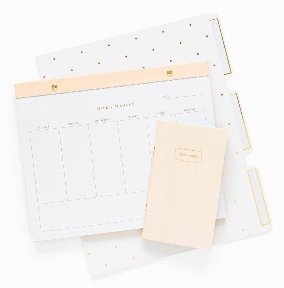 the weekly planner with a small booklet and folders