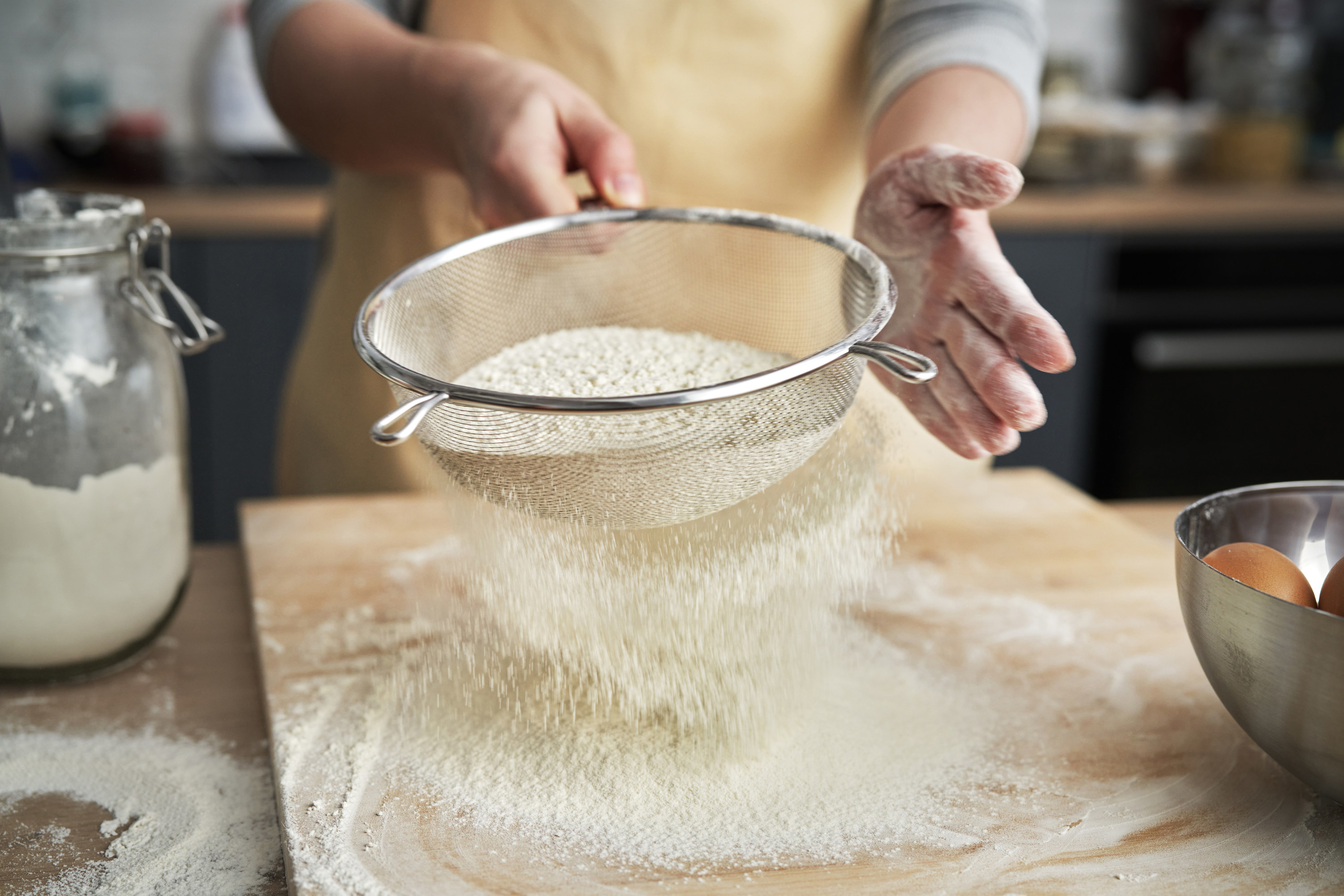 Sifting flour onto a cutting board