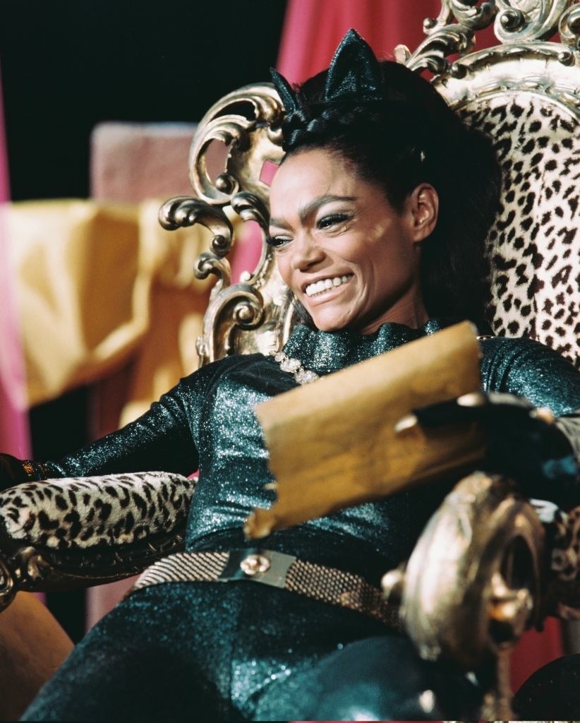 Eartha Kitt smiling for a photo wearing a green sparkly one piece