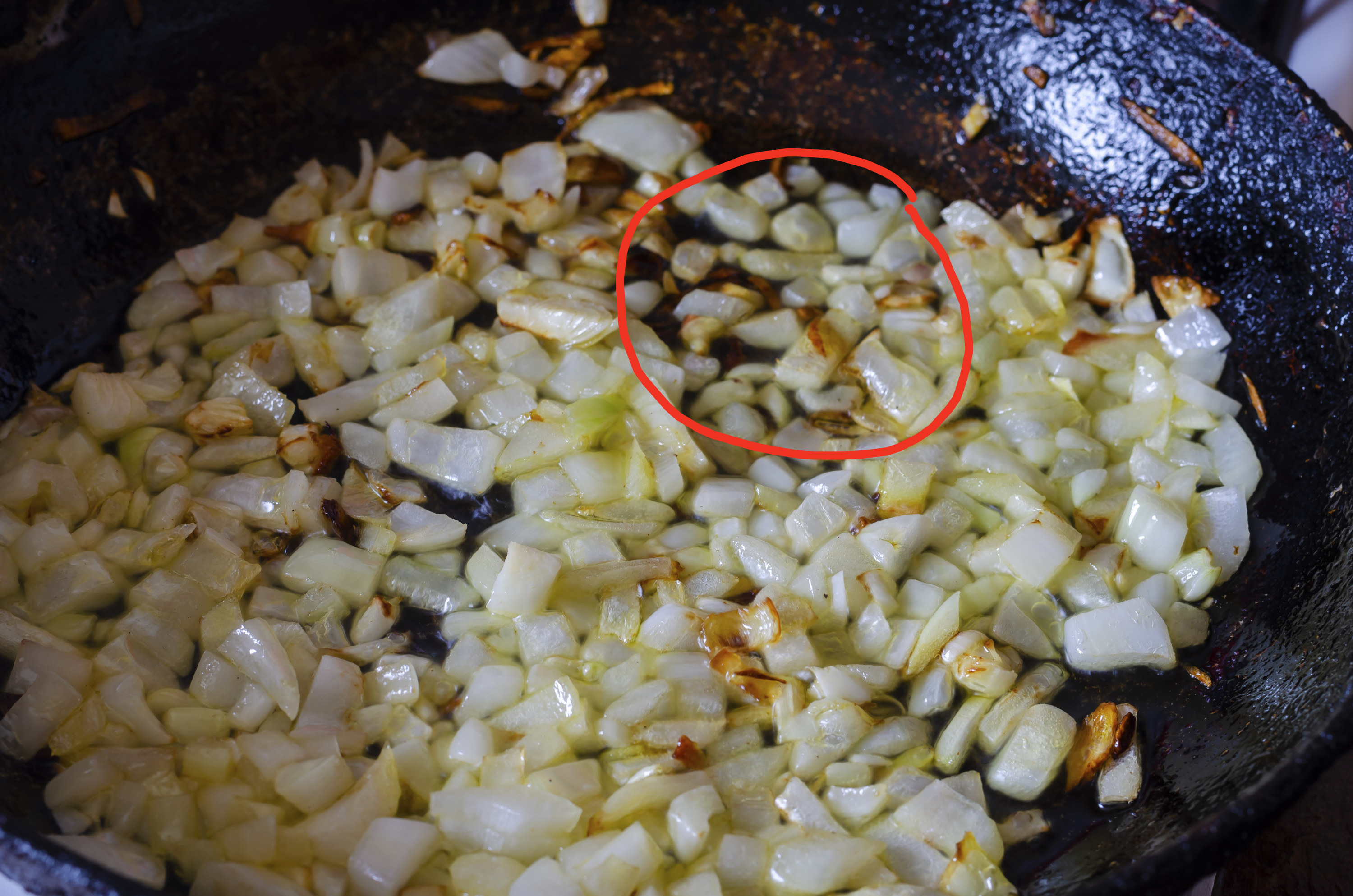 Burnt garlic sautéing with onions and circled