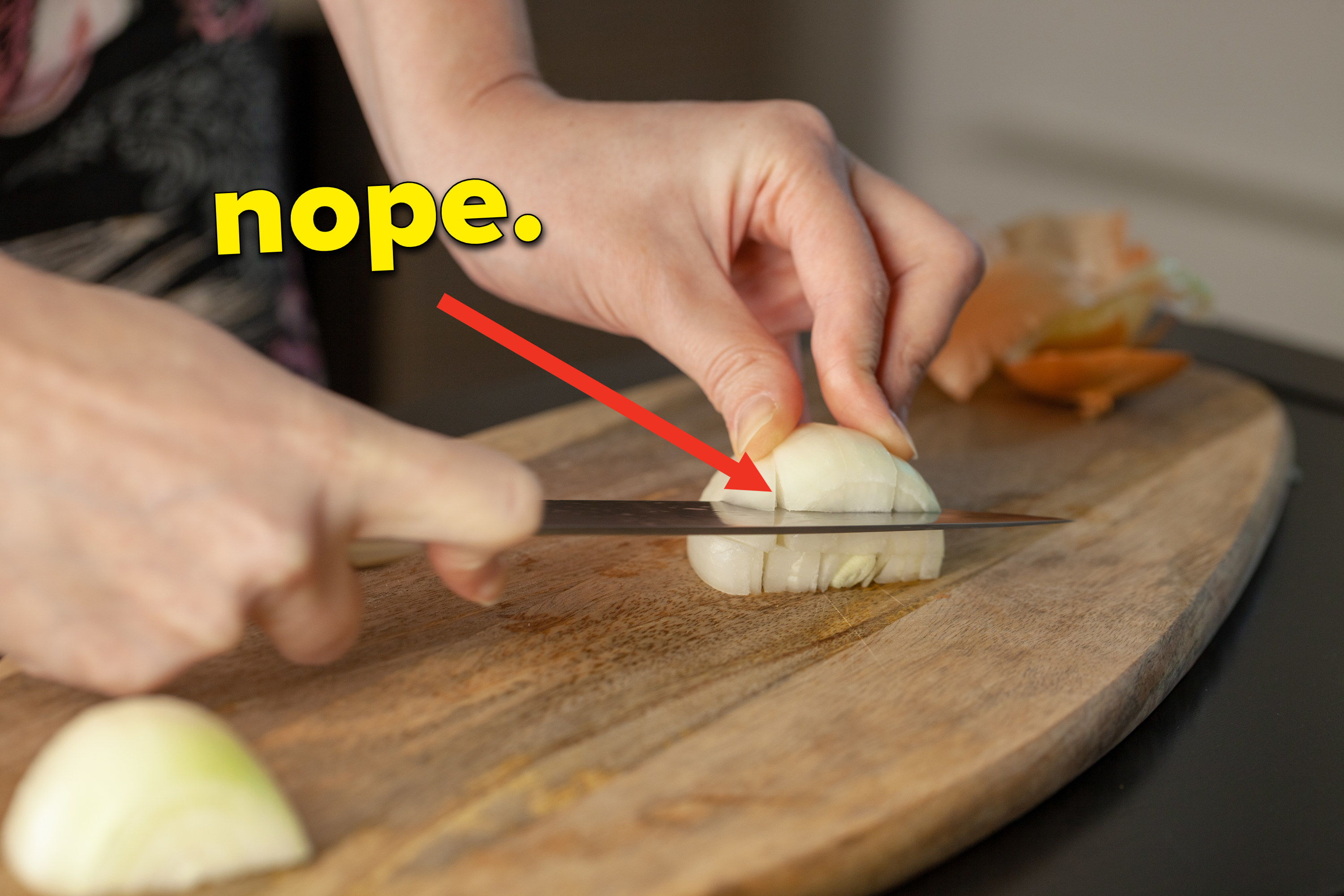 Onions being cut horizontally with arrow pointing to it saying &quot;nope&quot;