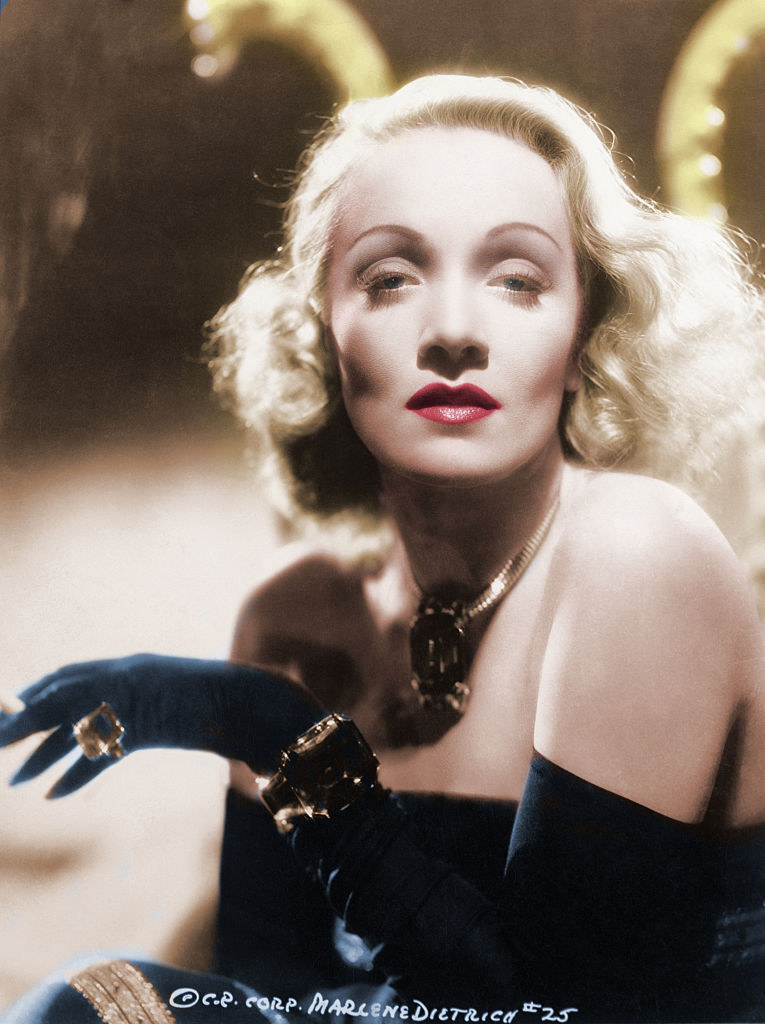 Marlene Dietrich posing for a photo wearing a midnight blue outfit