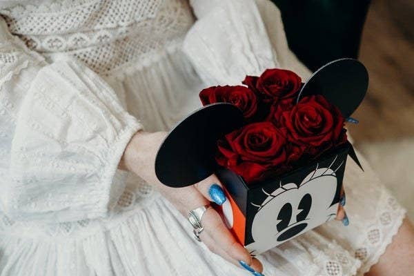 a minnie mouse box filled with four roses