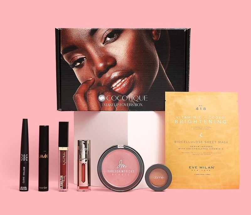 Black box with models face that reads &quot;Cocotique&quot; above variety of makeup products and face mask