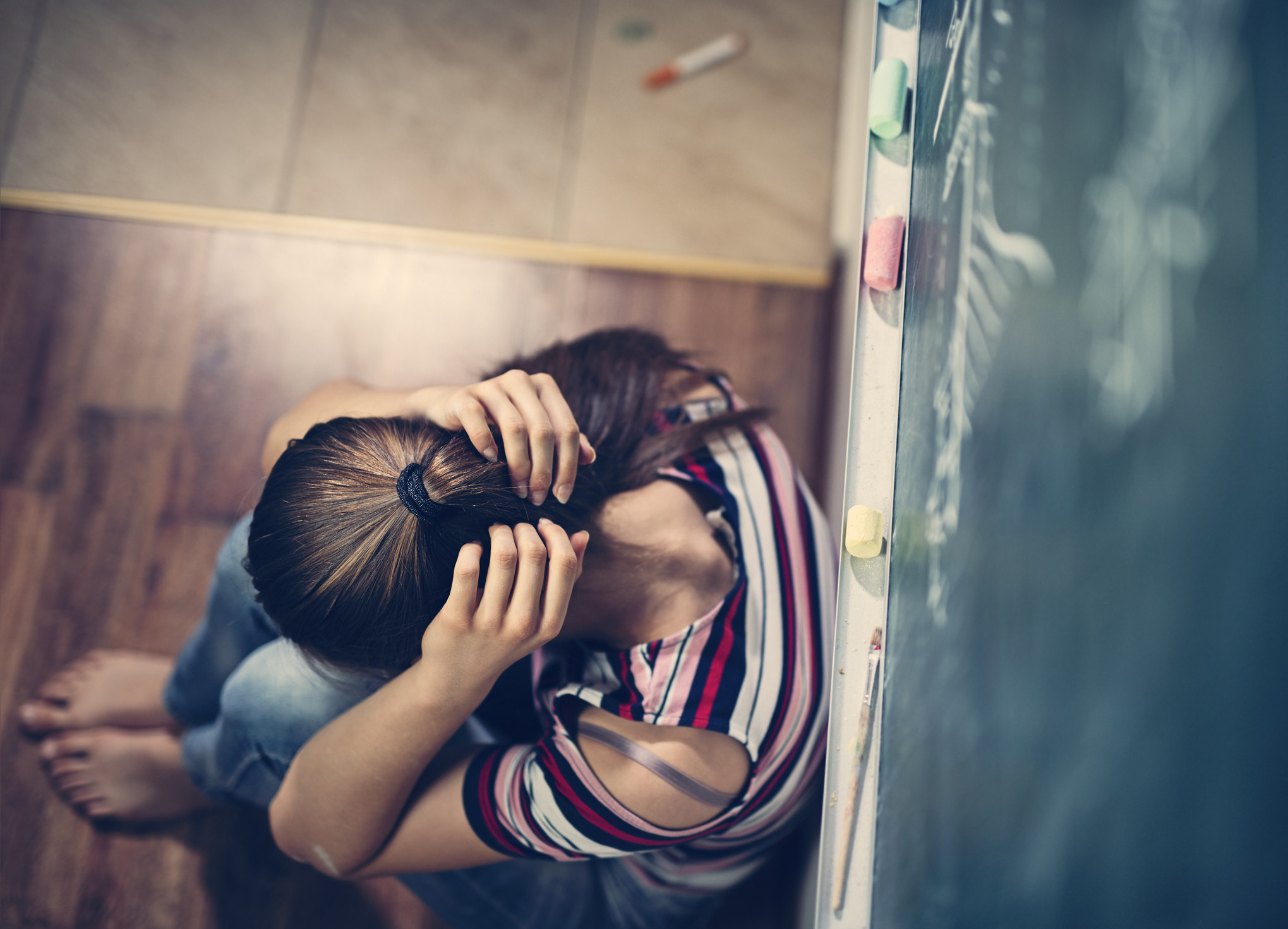 A girl crying in a classroom
