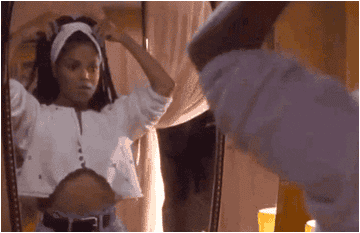 Janet Jackson in &quot;Poetic Justice&quot; touches up her iconic braids in the mirror