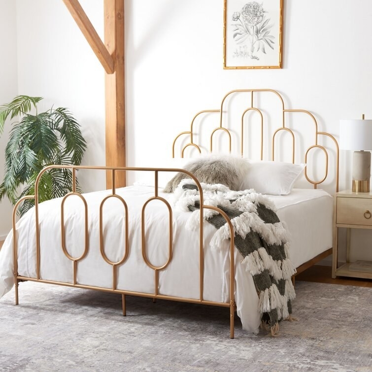 Golden vintage-inspired bed frame staged in a bedroom