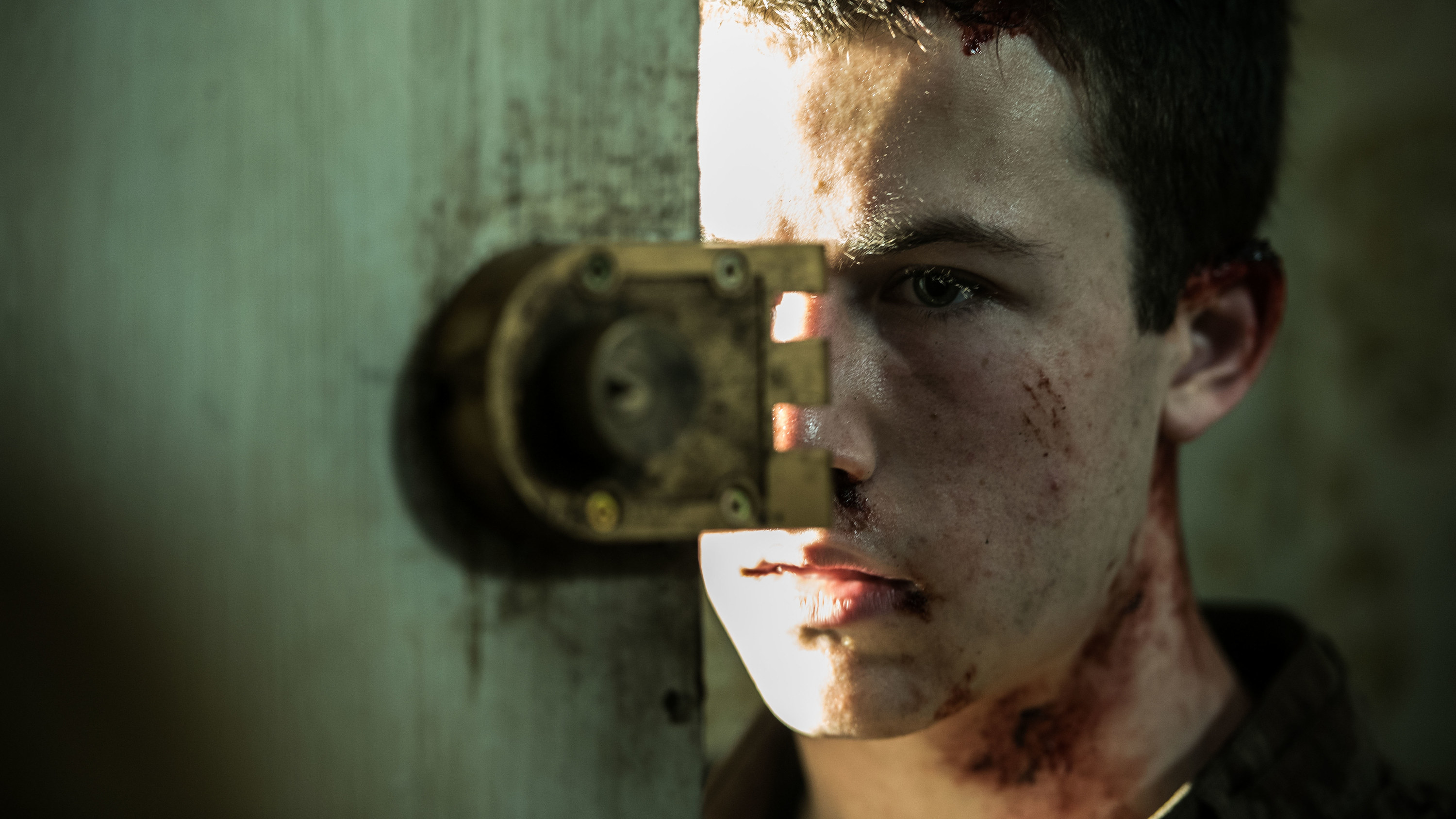 Dylan&#x27;s bloody character looking from behind a door