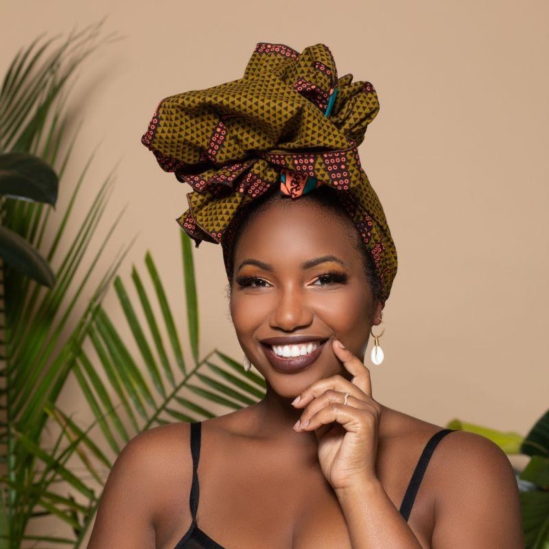 model wearing an olive green headwrap with geometric patterns on it