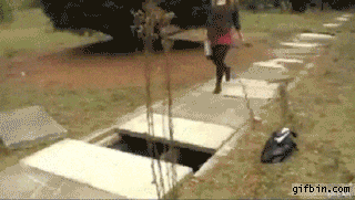 Woman tripping over hole in ground