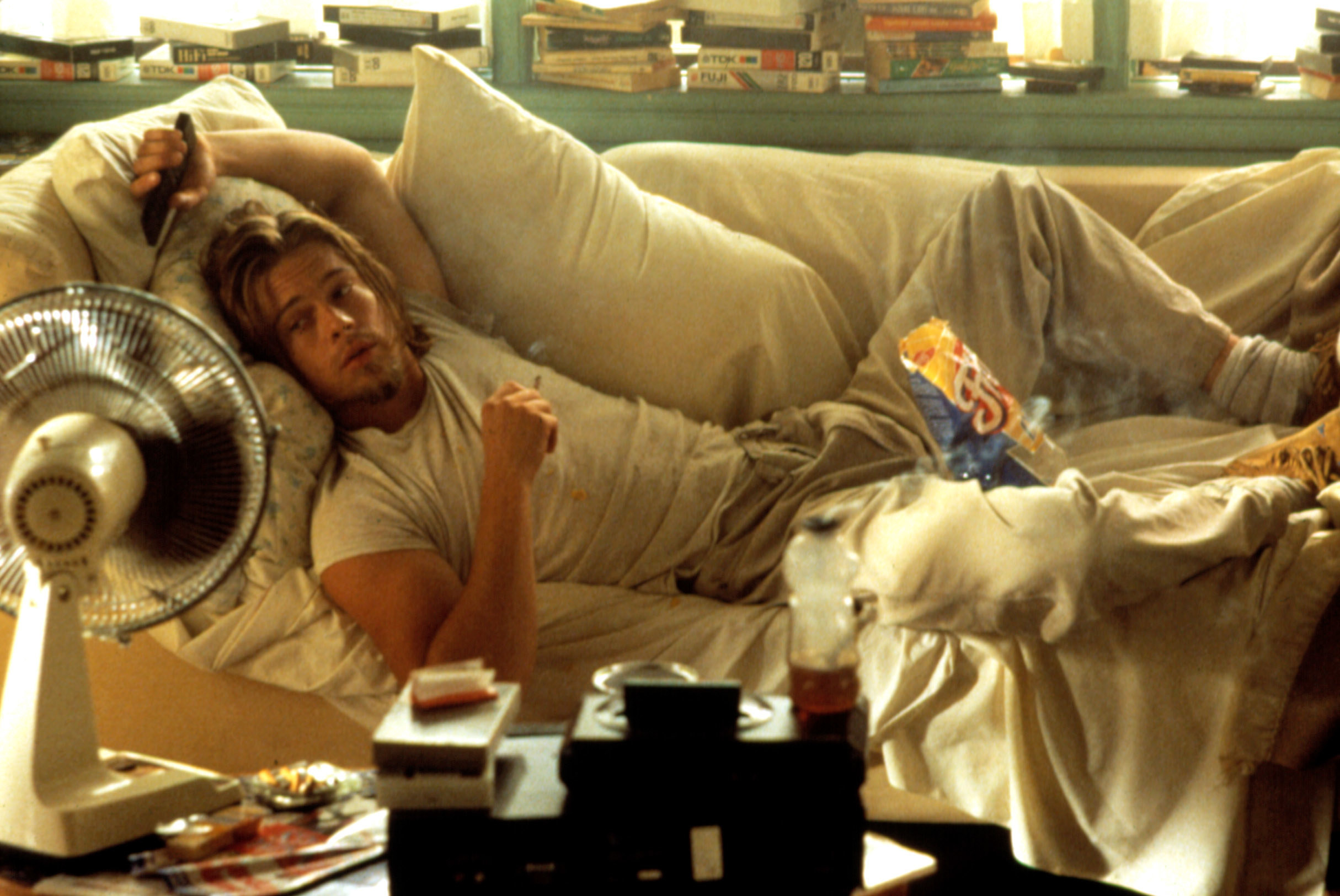 Brad Pitt as a stoner, lying on a sofa eating Fritos