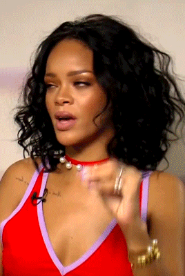 Rihanna sits in her chair and leans against the arm before squinting and saying &quot;What?&quot;