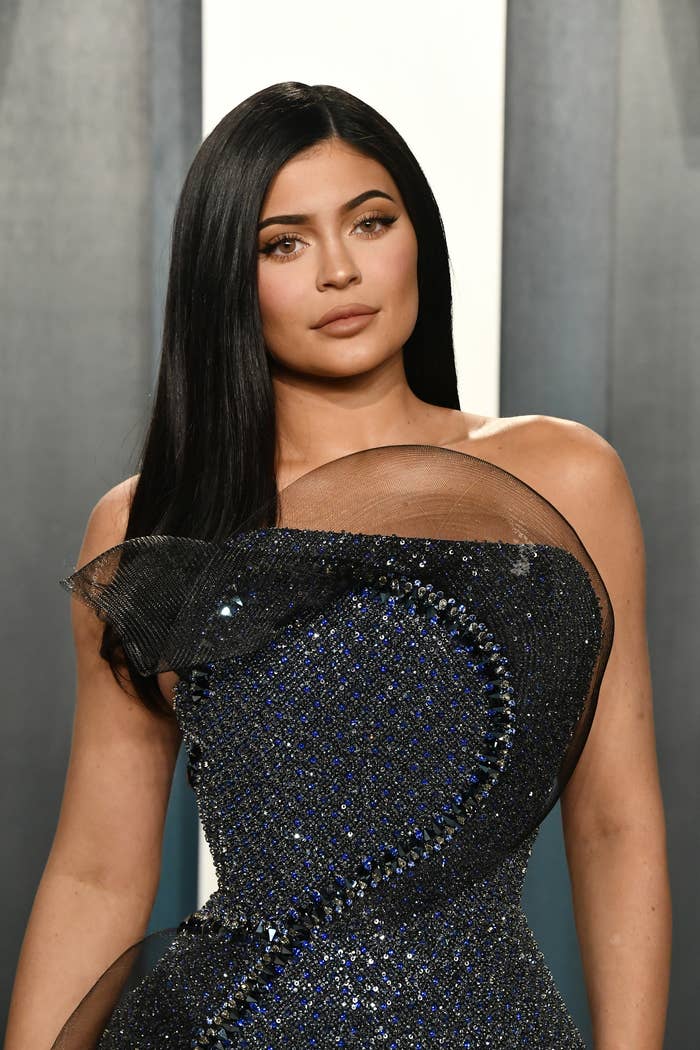 Kylie poses ina strapless sequined dress at an Oscars afterparty