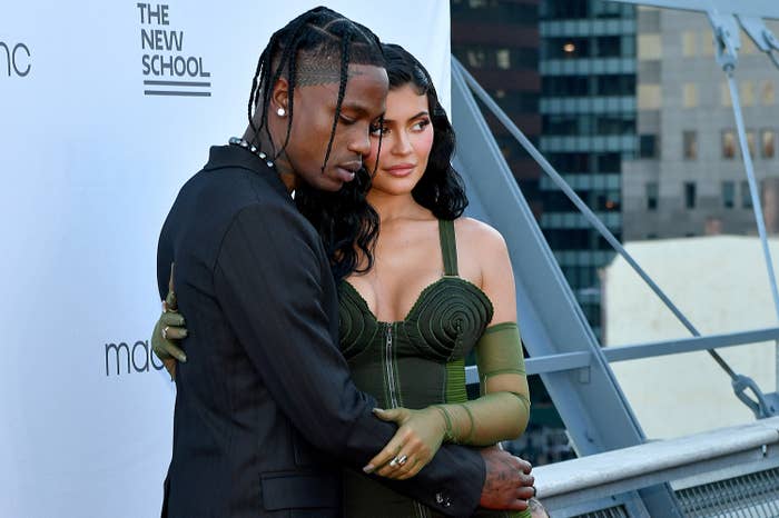 Travis and Kylie arm-in-arm as they pose for photographers on the red carpet