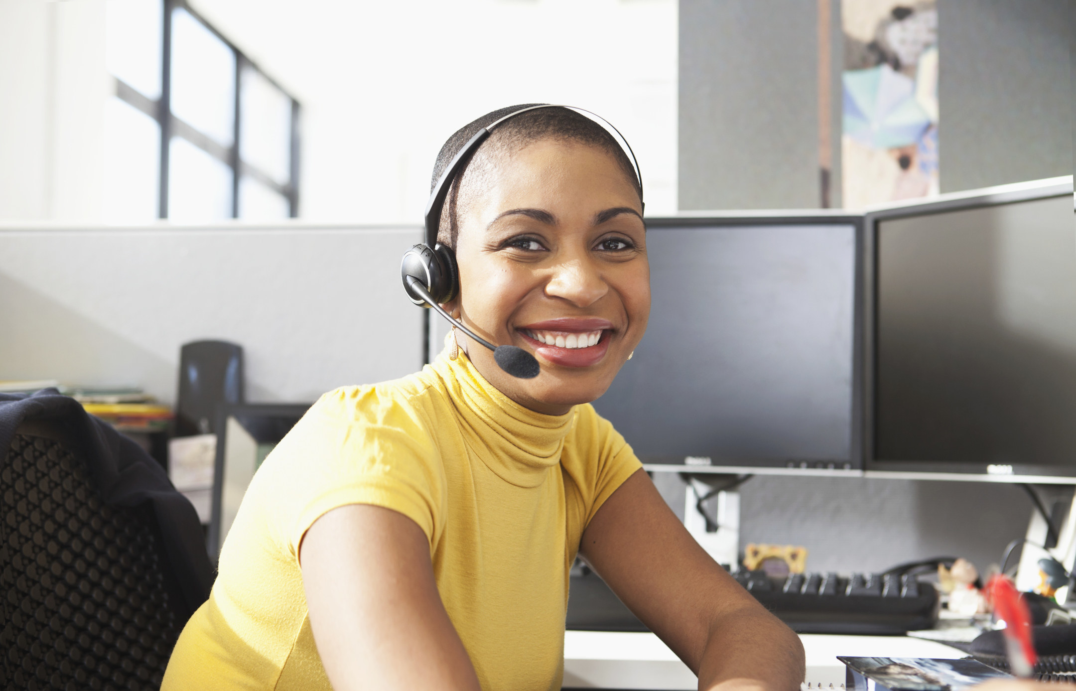 A call center worker smiles