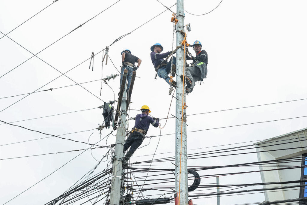 Workers fixing electric lines