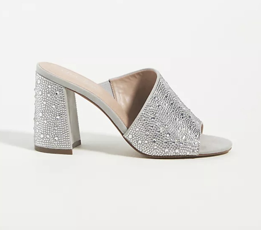 The sparkly silver mules have various sized crystal embellishments