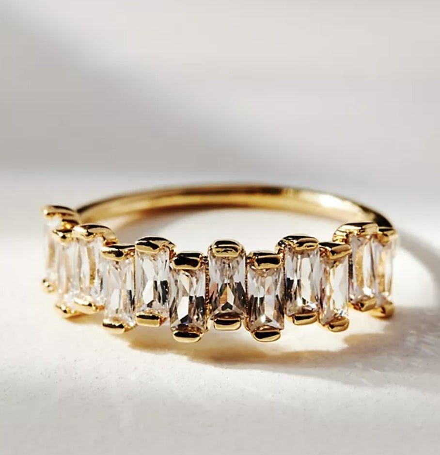 There is a gold ring with stacked crystals at various different heights