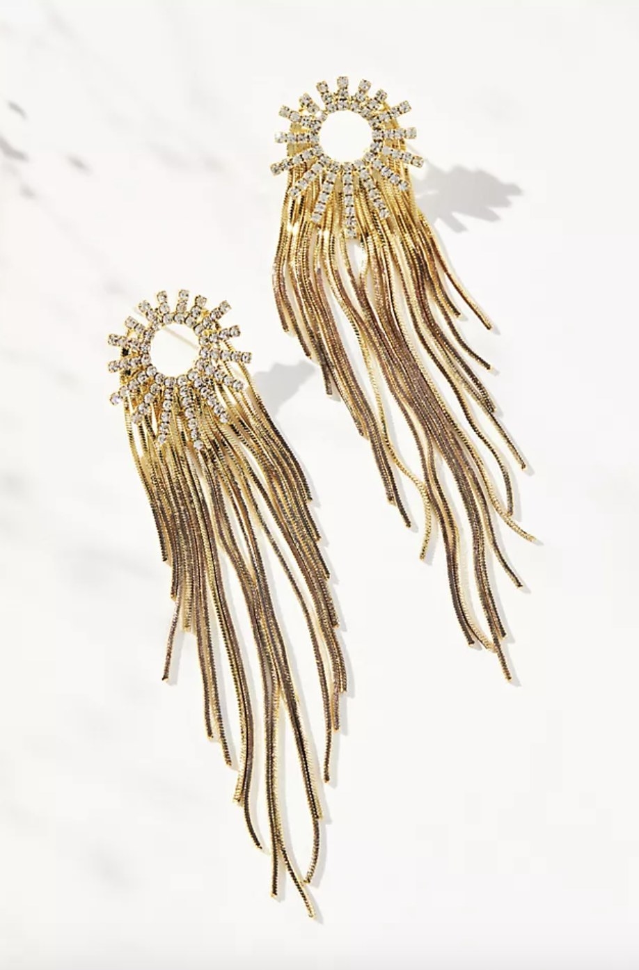 The gold drop earrings have a sun ray base and long dropping arms of gold