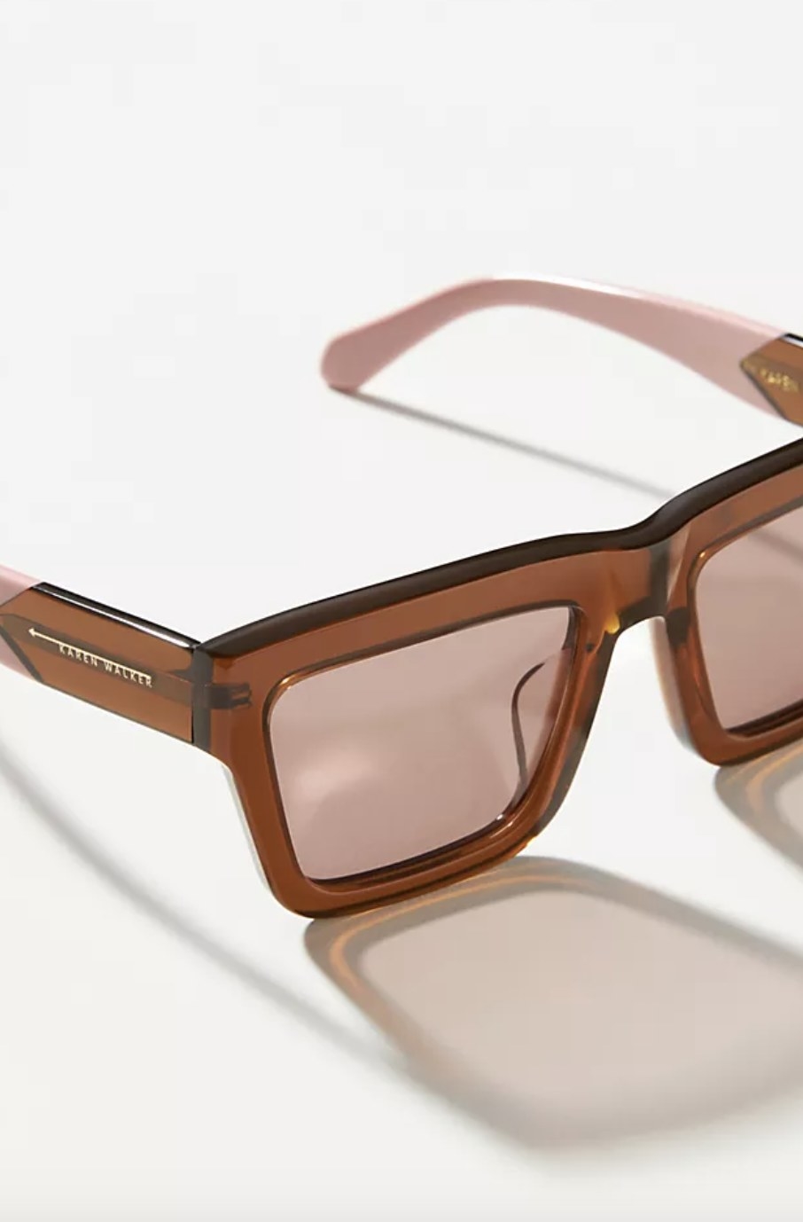 The sunglasses are a bronze color with light pink accents