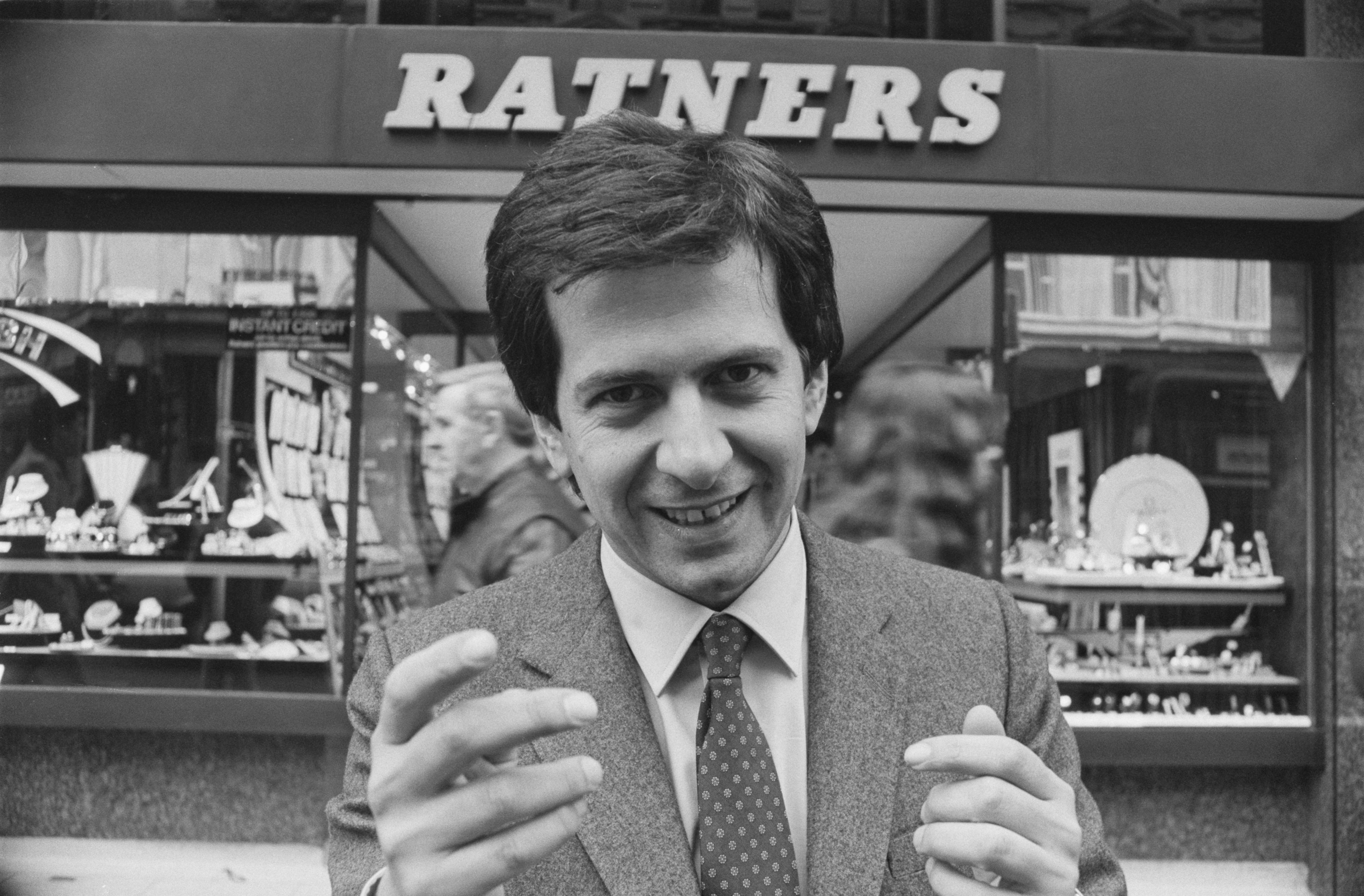 Gerald Ratner posing in front of a Ratners jewelry store