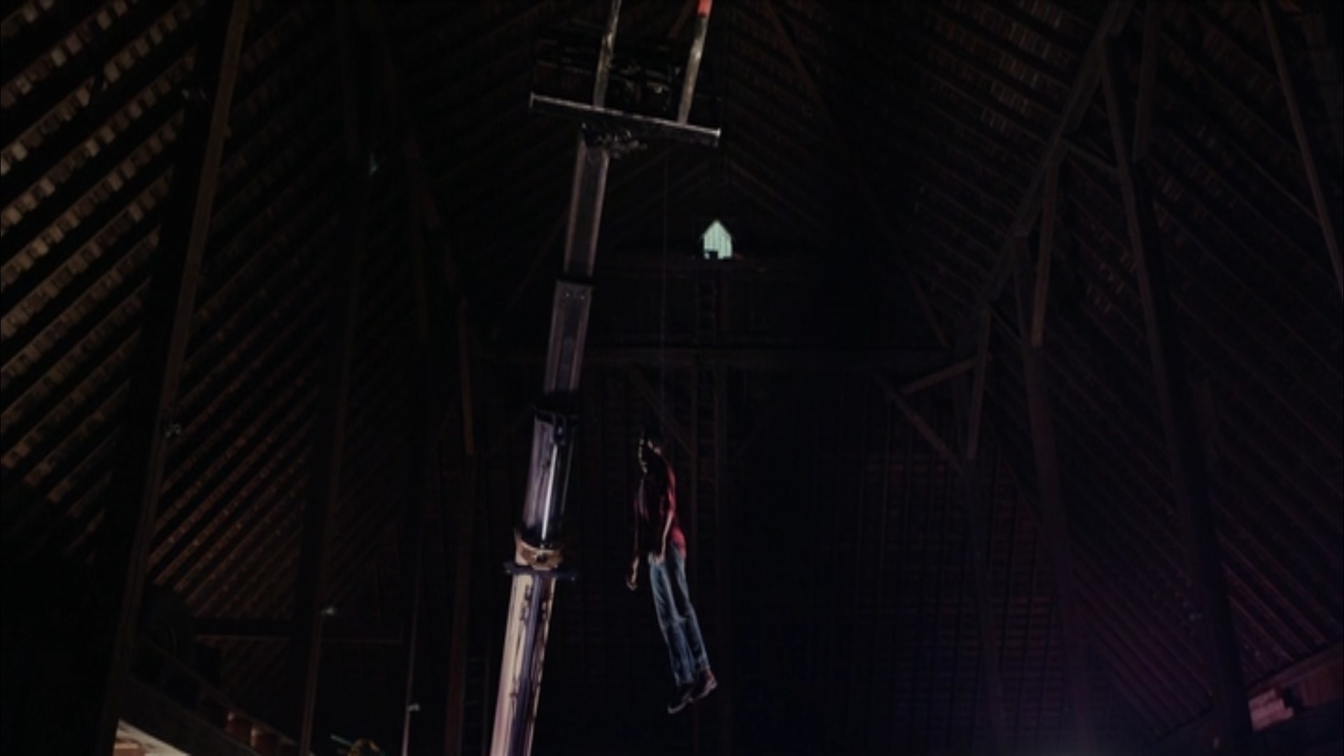 A man&#x27;s dead body hangs from a crane by a rope